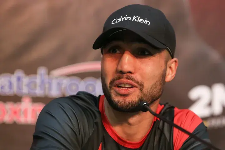 Welterweight contender Shakhram Giyasov sits in front of a microphone at a press conference.