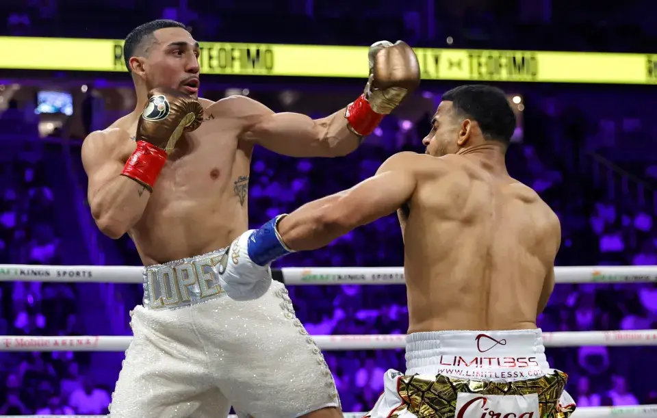 Rolly Romero [right] feels the force of Teofimo Lopez's left hand