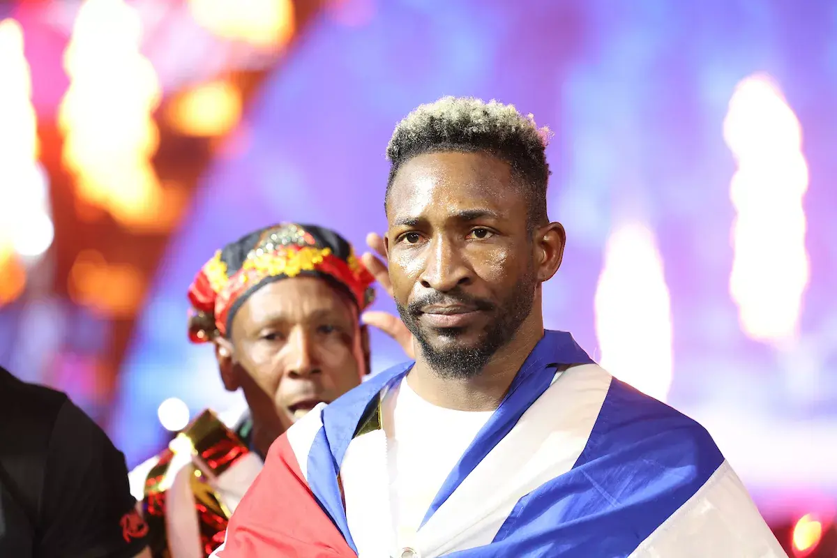 William Scull walks to the ring with a Cuban flag wrapped over his shoulders, and a team member walking behind him, for his fight against Canelo Alvarez on May 3, 2025.