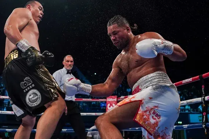 Zhilei Zhang watches Joe Joyce fall at his feet in their September 2023 rematch
